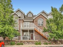 Beautiful townhome with brick and siding exterior, balcony, gated patio, and landscaped entrance at 16366 E Fremont Ave # 11, Aurora, CO 80016