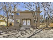 Two-story exterior of a home featuring a wooden facade, dual entryways and small balconies on the second floor at 4529 Barnacle Ct, Boulder, CO 80301