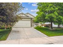 Charming single-Gathering home with a two-car garage and a well-manicured front yard at 11418 Macon St, Commerce City, CO 80640