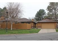 Charming exterior elevation of a home featuring a two-car garage and well-maintained landscaping at 95 S Eagle Cir, Aurora, CO 80012