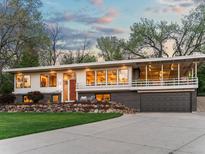 Stunning modern home with a large front yard, rock garden, covered balcony, and an attached garage at 11900 W 18Th Ave, Lakewood, CO 80215