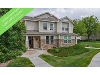 Charming two-story home with stone accents, a welcoming front porch, and well-maintained landscaping at 9758 Laredo St # 22D, Commerce City, CO 80022