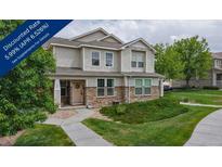 Charming two-story home with manicured lawn, stone accents and a welcoming front porch at 9758 Laredo St # 22D, Commerce City, CO 80022