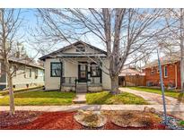 Charming home featuring a well-kept lawn, attractive landscaping, and a welcoming front porch area at 2676 S Lincoln St, Denver, CO 80210