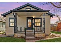 Charming bungalow with wrought iron porch railing, stucco siding, and black trim on a landscaped lot at 2676 S Lincoln St, Denver, CO 80210