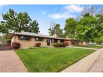 Charming ranch-style home featuring a well-maintained lawn and mature trees in a desirable neighborhood at 1840 E 84Th Ave, Denver, CO 80229