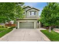 Charming two-story home featuring a well-maintained lawn and a two-car garage at 10294 Spotted Owl Ct, Highlands Ranch, CO 80129