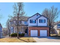 Charming two-story home with a brick-accented two-car garage and classic architectural details at 13434 W 62Nd Pl, Arvada, CO 80004