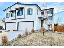 Charming two-story home with a three car garage and modern white and dark trim at 5347 Osceola St, Denver, CO 80212