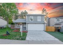 Charming two-story home with a well-manicured lawn and an attached two-car garage at 4249 S Biscay Cir, Aurora, CO 80013