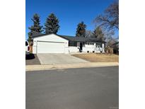 Charming single-story home with a well-maintained front yard and a two car attached garage at 1323 W 100Th Pl, Northglenn, CO 80260