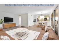 Bright living room flows to kitchen and dining, with a large window to the enclosed patio offering Cheesman Park views at 1200 N Humboldt St # 604, Denver, CO 80218