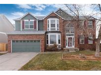 Charming two-story home with brick and siding, and a two-car garage at 9749 Newcastle Dr, Highlands Ranch, CO 80130