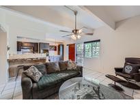 Cozy living room featuring an open floor plan, ceiling fan, and tiled floors at 384 S Ironton St # 314, Aurora, CO 80012