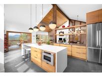 Bright, modern kitchen featuring a large island, stainless steel appliances, and mountain views at 1943 Columbine Ct, Golden, CO 80401