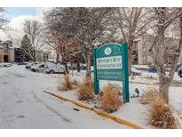 Hunter's Run Condominiums sign, snow covered entrance and parking lot at 2575 S Syracuse Way # 108, Denver, CO 80231