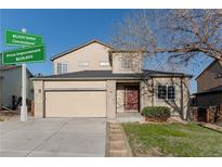 Charming two-story home with a two-car garage, nicely landscaped front yard, and updated signage at 2875 S Tower Way, Aurora, CO 80013