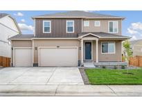 Two-story house with neutral siding, two-car garage, and a landscaped lawn at 13547 Valentia St, Thornton, CO 80602