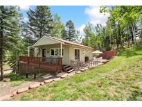 Charming single-Gathering home featuring a porch and outdoor seating at 7256 Aspen Meadow Dr, Evergreen, CO 80439