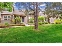 Charming townhome featuring well-manicured lawn and beautiful stone accents at 570 Clarendon Loop, Castle Pines, CO 80108