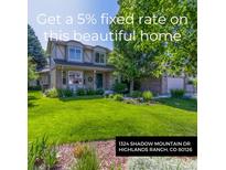 Charming two-story home featuring a well-manicured lawn and mature trees in a residential neighborhood at 1324 Shadow Mountain Dr, Highlands Ranch, CO 80126
