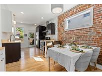 Modern kitchen features dark cabinetry, light countertops, and stainless steel appliances at 1217 E 26Th Ave, Denver, CO 80205