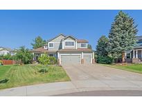 Charming two-story home with three-car garage and beautifully landscaped front yard at 10421 Kennemere Ln, Parker, CO 80134
