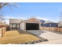 Charming ranch-style home features a black garage door, neutral paint, and a well-manicured front yard at 11304 Elm Dr, Thornton, CO 80233