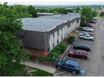 Apartment building showcasing brick facade, neutral siding, and ample parking in a landscaped setting at 9650 Huron St # 3, Thornton, CO 80260