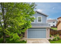 Charming two-story home with a well-maintained lawn, mature tree, and attached two-car garage at 2763 Dharma Ave, Broomfield, CO 80020