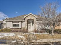 Nice Ranch style home with stone accents and a landscaped front yard at 671 Stafford Cir, Castle Rock, CO 80104