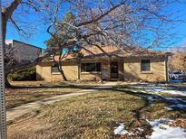 Ranch style home with mature trees and a well-maintained lawn at 1759 N Olive St, Denver, CO 80220