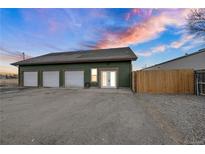 Green three-car garage with extra storage space at 260 4Th Ave, Hudson, CO 80642