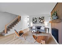 Bright living room featuring modern furnishings, striking artwork, and a cozy fireplace, perfect for relaxing and entertaining at 5667 S Lowell Blvd, Littleton, CO 80123