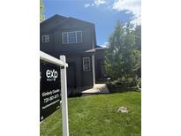 Charming two-story home featuring a well-manicured lawn and professional real estate signage at 1464 Spotted Owl Way, Highlands Ranch, CO 80129