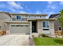 Charming two-story home featuring a two-car garage and manicured lawn at 24717 E 40Th Ave, Aurora, CO 80019