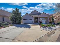 Charming single-story home with manicured landscaping, stone accents, and a spacious driveway at 6638 S Tibet Ct, Aurora, CO 80016