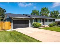 Charming single-story home boasts a well-maintained front yard and an attached two-car garage at 3461 S Ivy Way, Denver, CO 80222