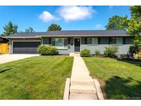 Charming home with a well-manicured lawn and a inviting walkway leading to the front door at 3461 S Ivy Way, Denver, CO 80222