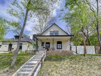 Charming front exterior of home with peaked roof, brick facade, and welcoming front porch at 458 S Downing St, Denver, CO 80209