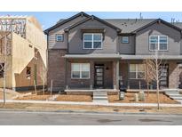 New construction of a two-story townhouse with brick and siding at 765 N Tibet St, Aurora, CO 80018