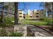 Inviting multi-unit property with lush lawn, mature trees, and prominent signage, offering a serene residential environment at 2711 Mapleton Ave # 27, Boulder, CO 80304
