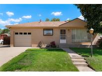 Charming one-story home with brick exterior, well-manicured lawn, and attached garage, perfect for comfortable living at 1803 Graves Ct, Northglenn, CO 80233