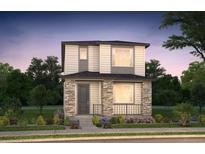 Charming two-story home with a stone-accented front porch and professionally landscaped yard at 21176 E 62Nd Dr, Aurora, CO 80019
