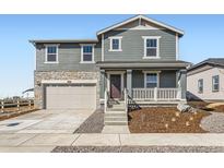 Charming two-story home with a stone-accented garage, inviting porch, and well-maintained landscaping at 3909 N Shawnee St, Aurora, CO 80019