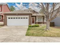Charming single-Gathering home showcasing a two-car garage, manicured lawn and inviting curb appeal in a residential neighborhood at 5463 Rockhampton Cir, Highlands Ranch, CO 80130