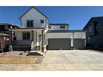Charming two-story home with a three-car garage and inviting front porch at 786 Sawdust Dr, Brighton, CO 80601