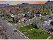 Charming neighborhood street view with well-maintained homes and a mountain backdrop at 2201 Illinois St, Golden, CO 80401