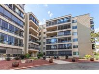 Exterior view of building with balconies, landscaping, and parking area with blue skies overhead at 13961 E Marina Dr # 414, Aurora, CO 80014