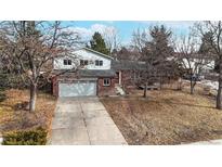 Brick ranch home with attached garage and mature trees at 954 Coral Ct, Castle Rock, CO 80104